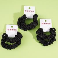 2 pieces of black headbands with rhinestone decorations and elastic bands for ponytails