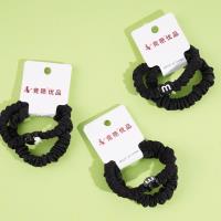 2 pieces of black small intestine tips tied with string and rubber bands in the shape of a heart