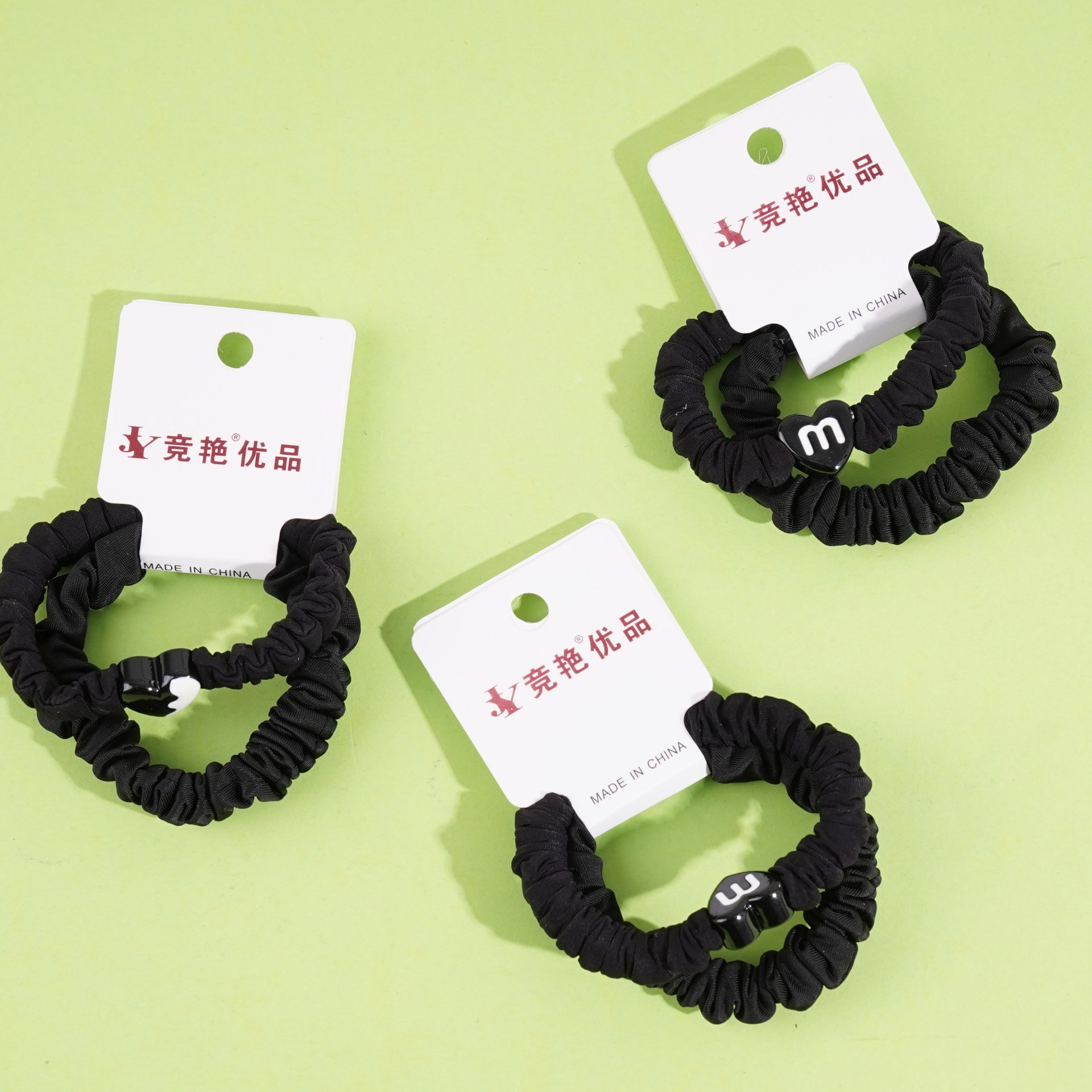 2 pieces of black small intestine tips tied with string and rubber bands in the shape of a heart