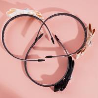 Une pince à cheveux en forme de nœud papillon, décorée de diamants et de perles.