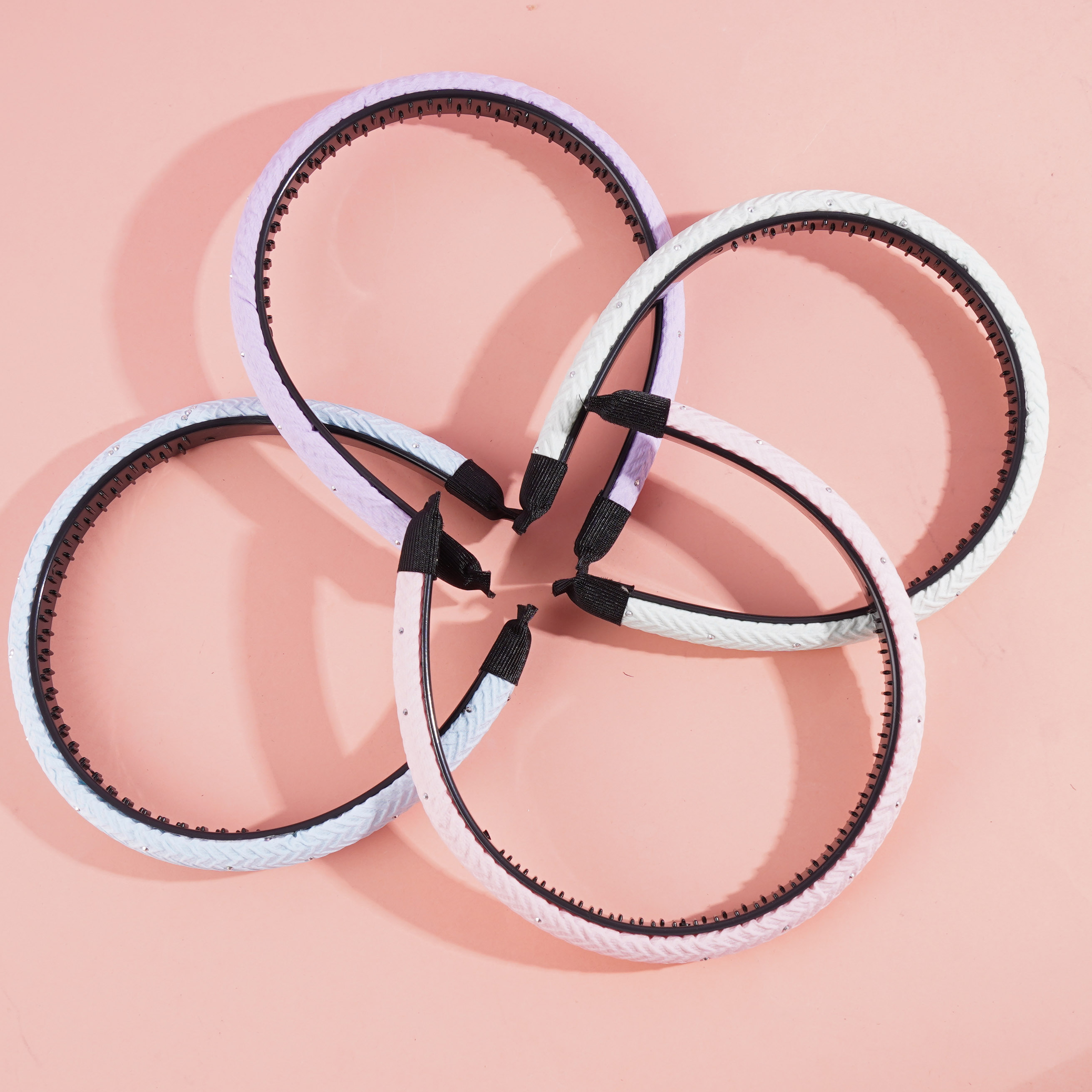 A small, colorful hairpin with a ruffled design and a sparkling gemstone in the center