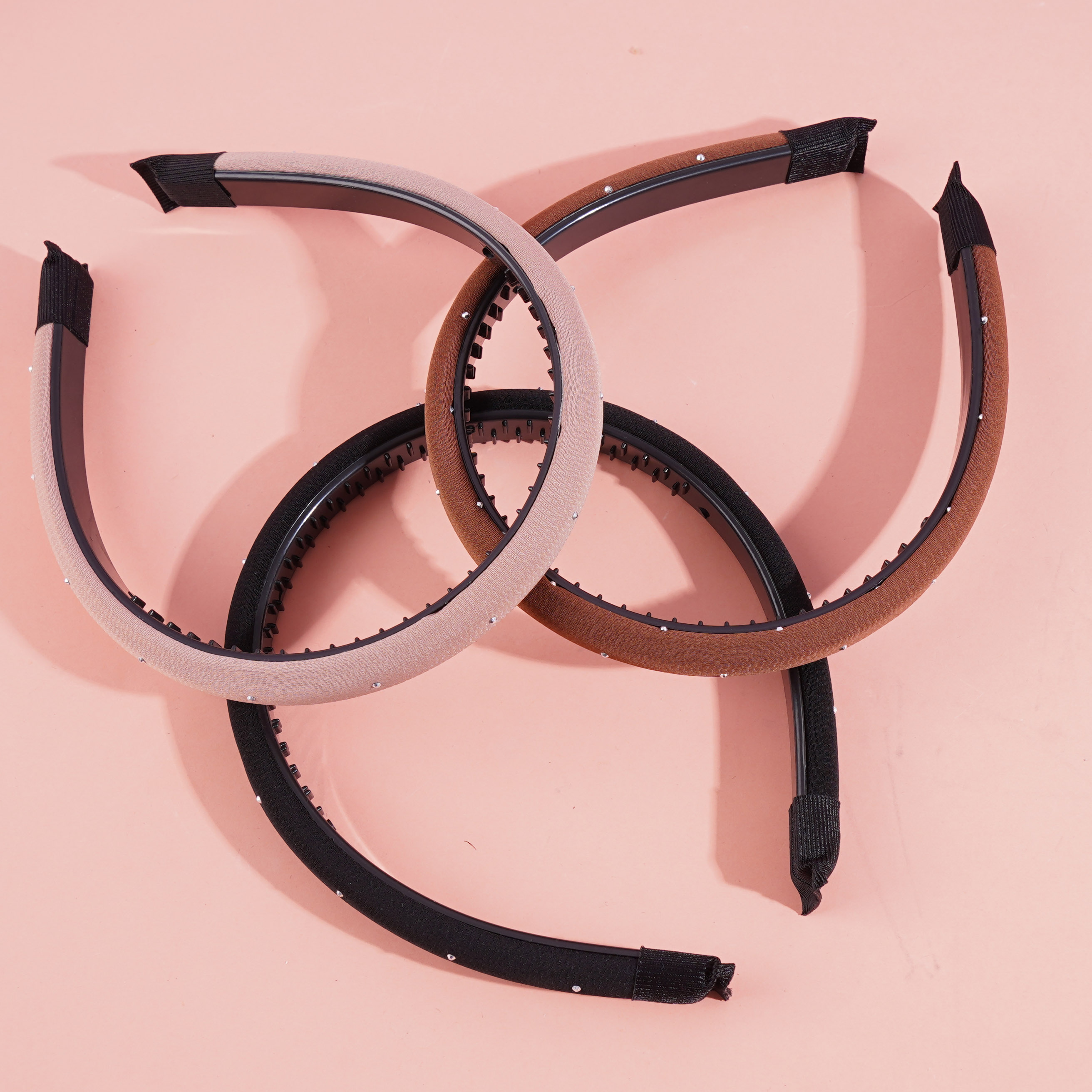 A small dark-colored diamond and sponge-headed hair clip