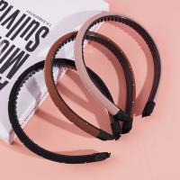 A small dark-colored diamond and sponge-headed hair clip