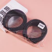 A small dark-colored diamond and sponge-headed hair clip