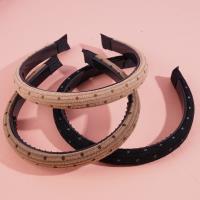 A small sponge-headed hair clip with dark dots