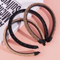 A small sponge-headed hair clip with dark dots