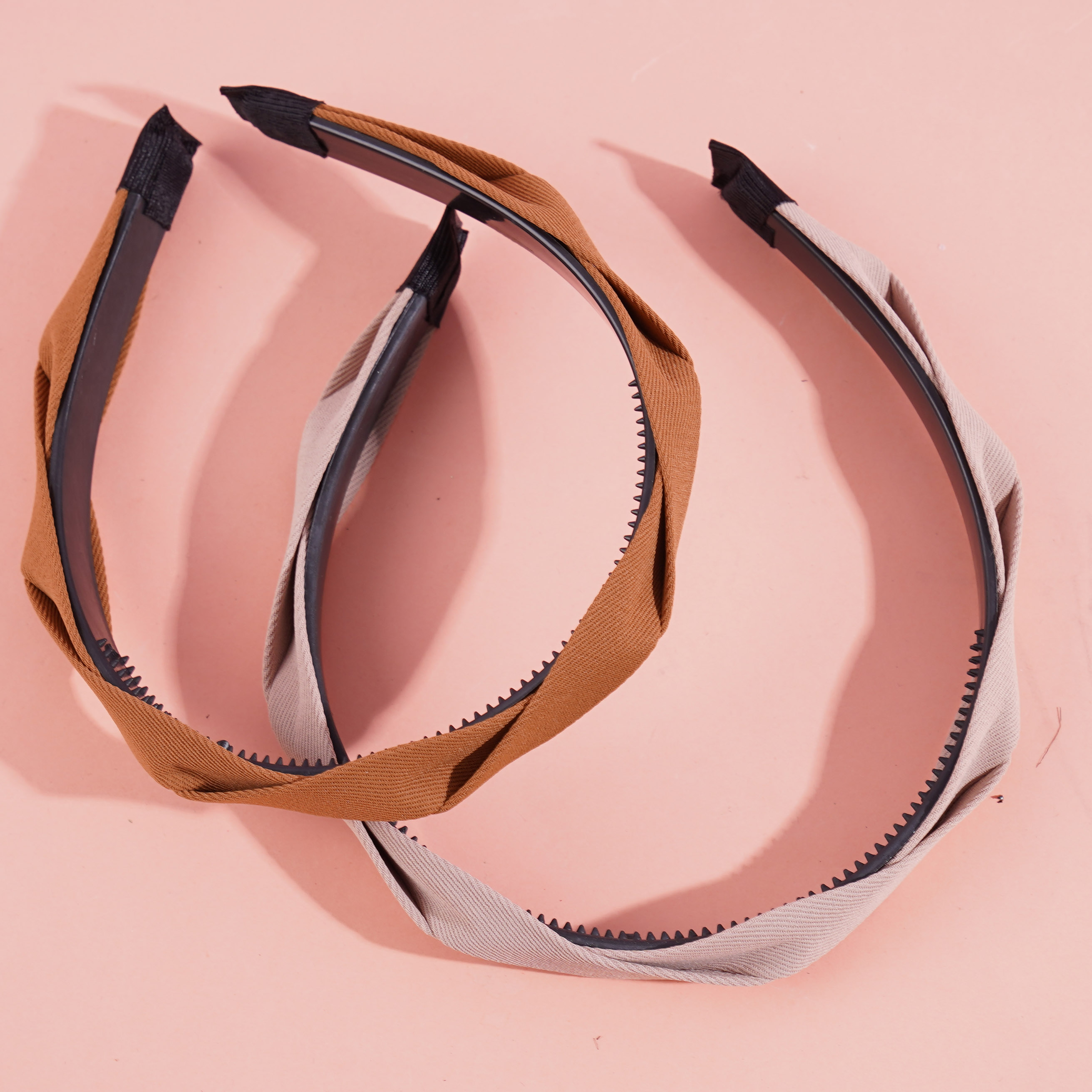 A dark-colored headband and hair clip from Mashua