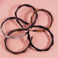 A dark-colored headband and hair clip from Mashua