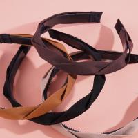 A dark-colored headband and hair clip from Mashua