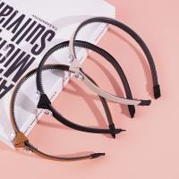 A dark-colored double-diamond headband buckle with a knotted design