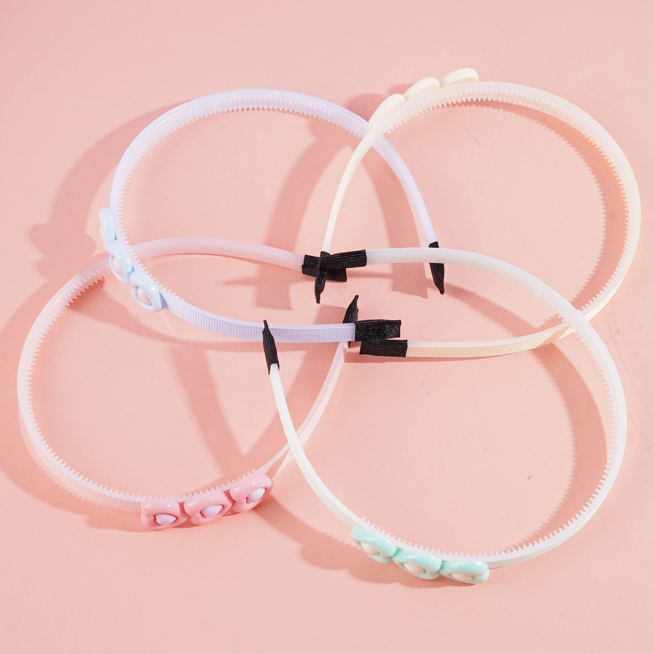 Three heart-shaped children's headbands with hair clips