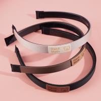 Silk satin headband with a logo-embossed buckle