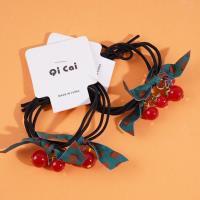 2 red beads, green ribbon headbands, and rubber bands