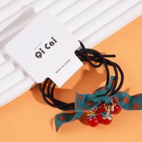 2 red beads, green ribbon headbands, and rubber bands