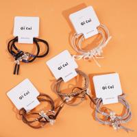 2 small white flower-themed headbands with elastic bands