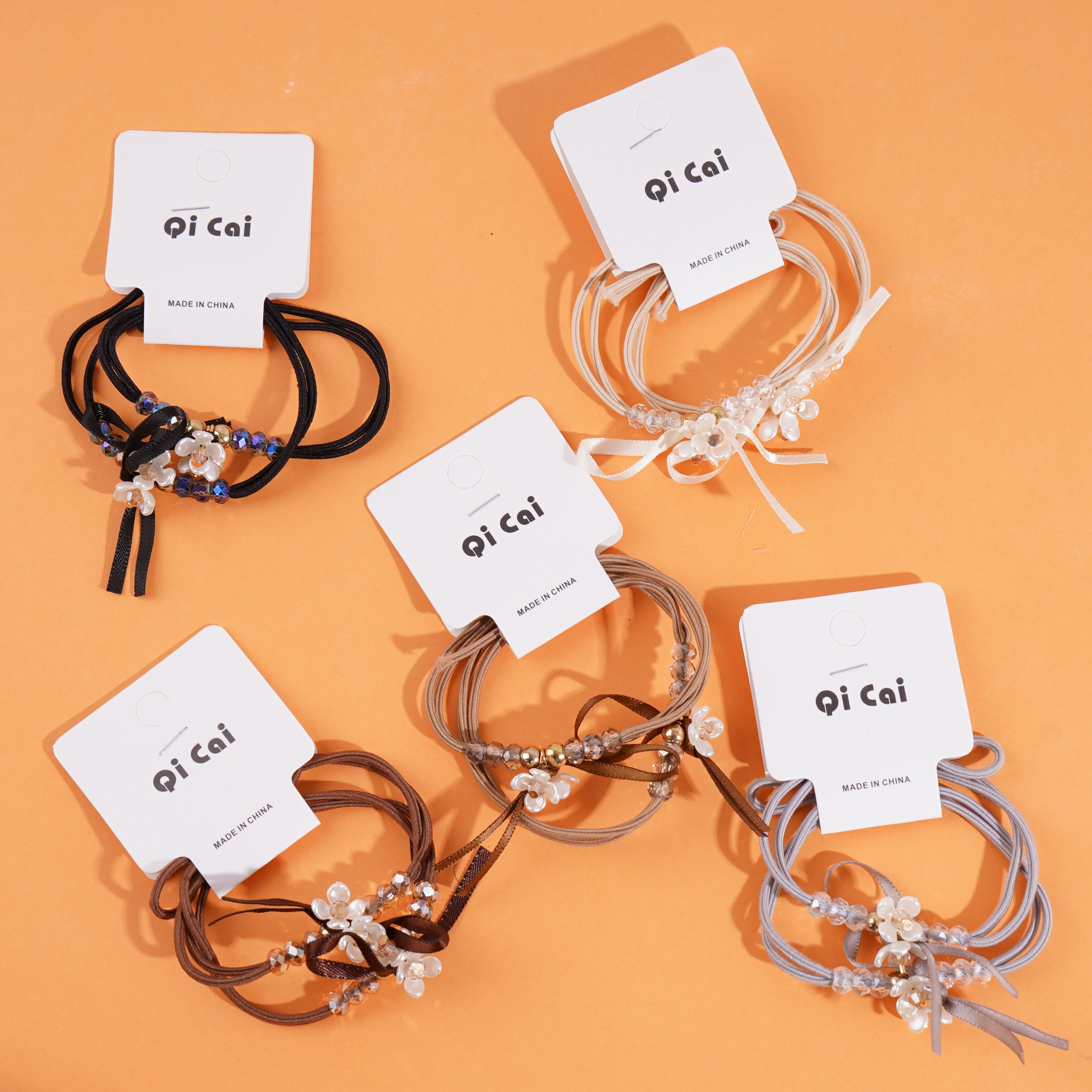 2 small white flower-themed headbands with elastic bands