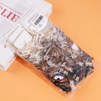 2 small white flower-themed headbands with elastic bands