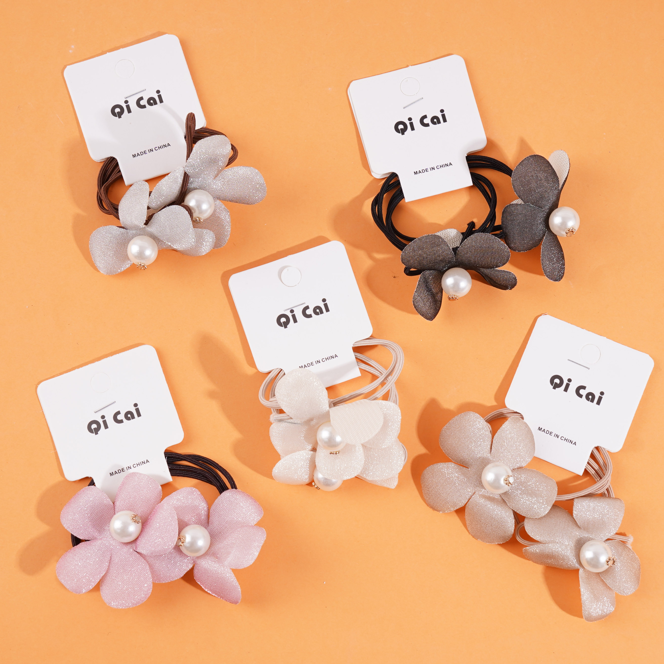 2 flower-shaped sponge headbands with elastic bands