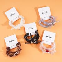 2 pieces of rose sausage with a looped string and rubber bands