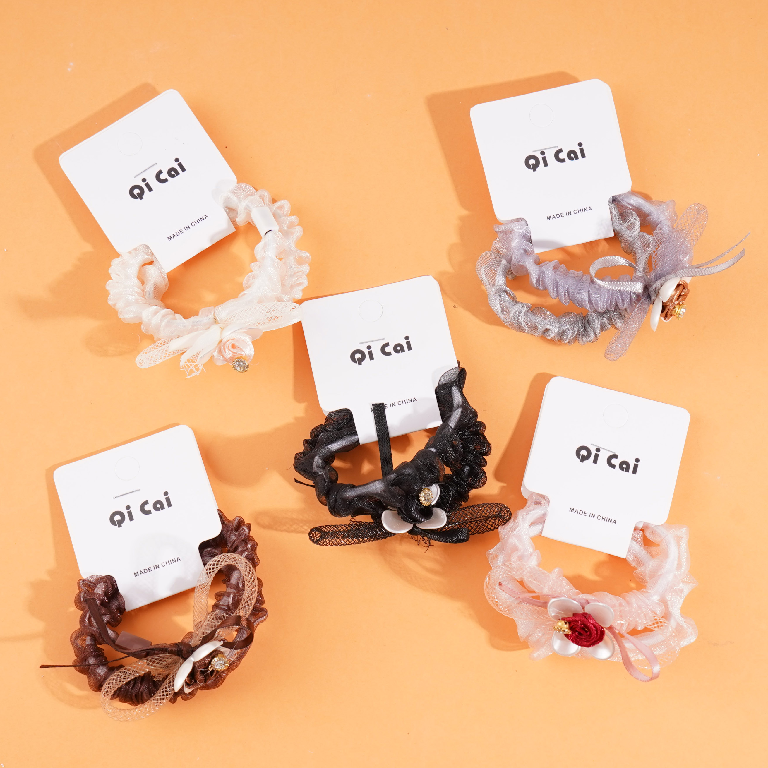 2 pieces of rose sausage with a looped string and rubber bands