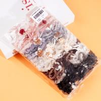 2 pieces of rose sausage with a looped string and rubber bands