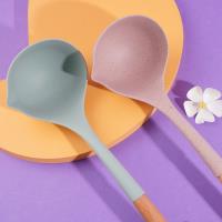 A silicone spatula with a wooden handle and a spoon-shaped head