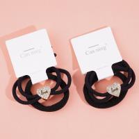 2 heart-shaped diamond boxes containing headbands and rubber bands