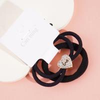 2 heart-shaped diamond boxes containing headbands and rubber bands