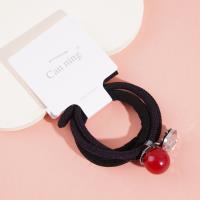 2 red bead-encrusted boxes containing headbands and rubber bands