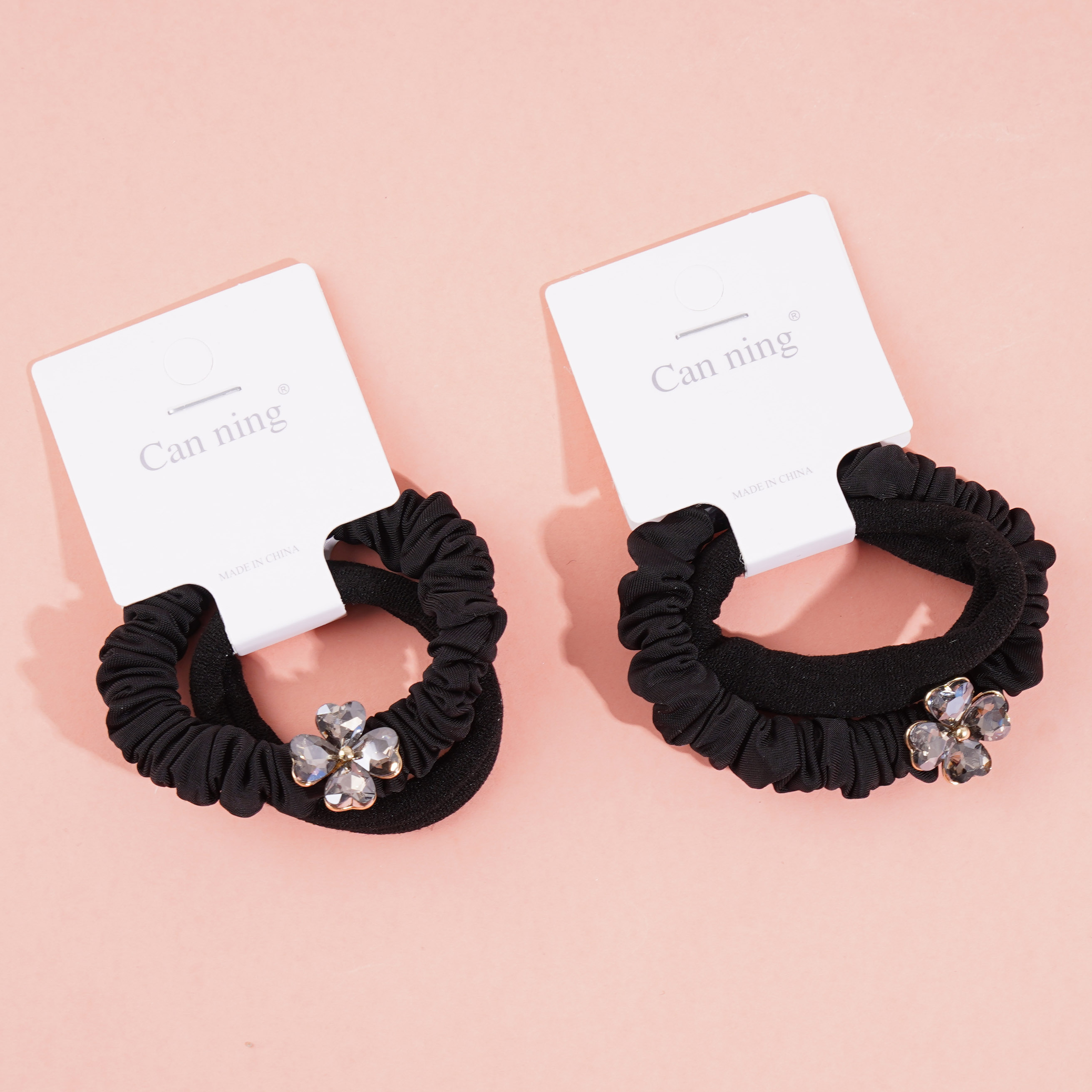 2 four-leaf clover-themed headbands with elastic bands, packaged in a box