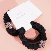 2 four-leaf clover-themed headbands with elastic bands, packaged in a box