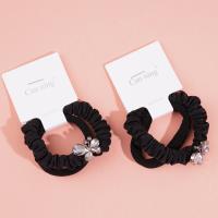 2 large butterfly-shaped jewelry boxes containing headbands and rubber bands