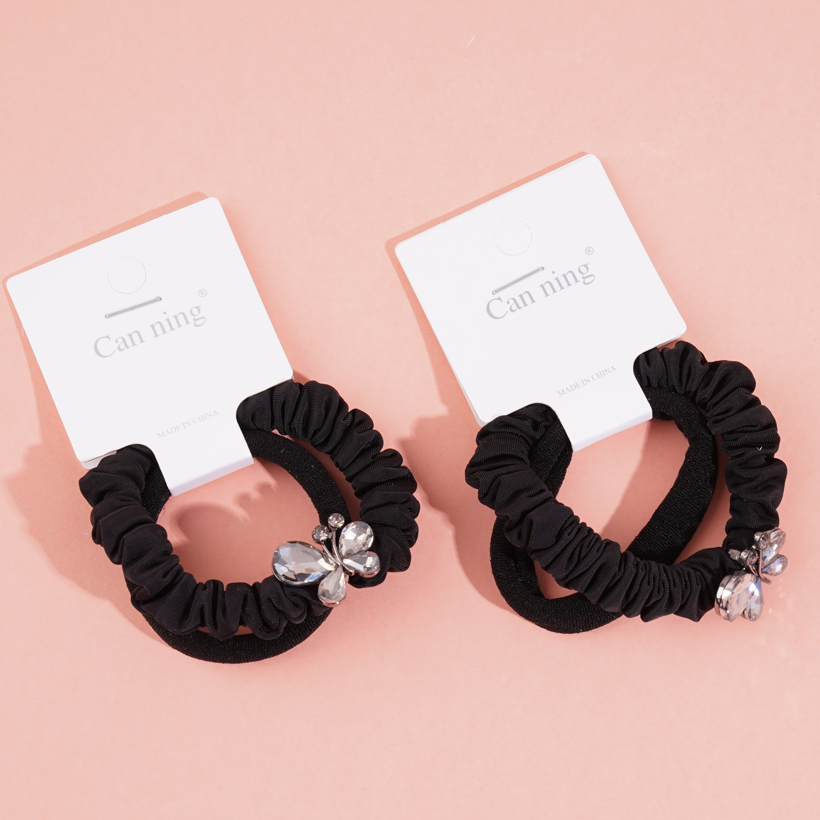 2 large butterfly-shaped jewelry boxes containing headbands and rubber bands