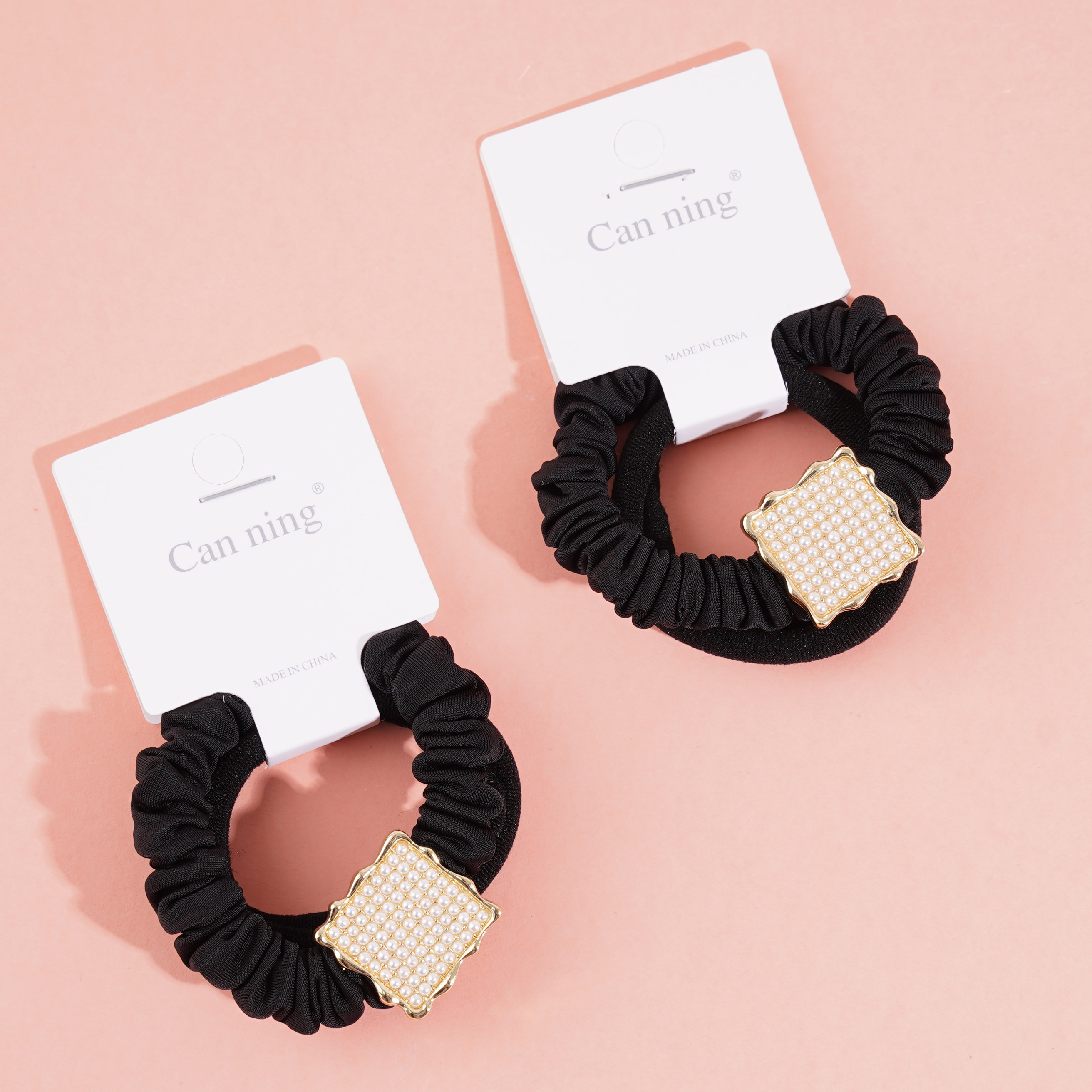 2 square pearl boxes containing headbands and hair ties