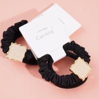 2 square pearl boxes containing headbands and hair ties