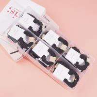 2 square pearl boxes containing headbands and hair ties