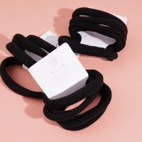 4 élastiques à cheveux avec des embouts en forme de serviette noire.