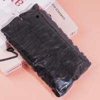 4 élastiques à cheveux avec des embouts en forme de serviette noire.