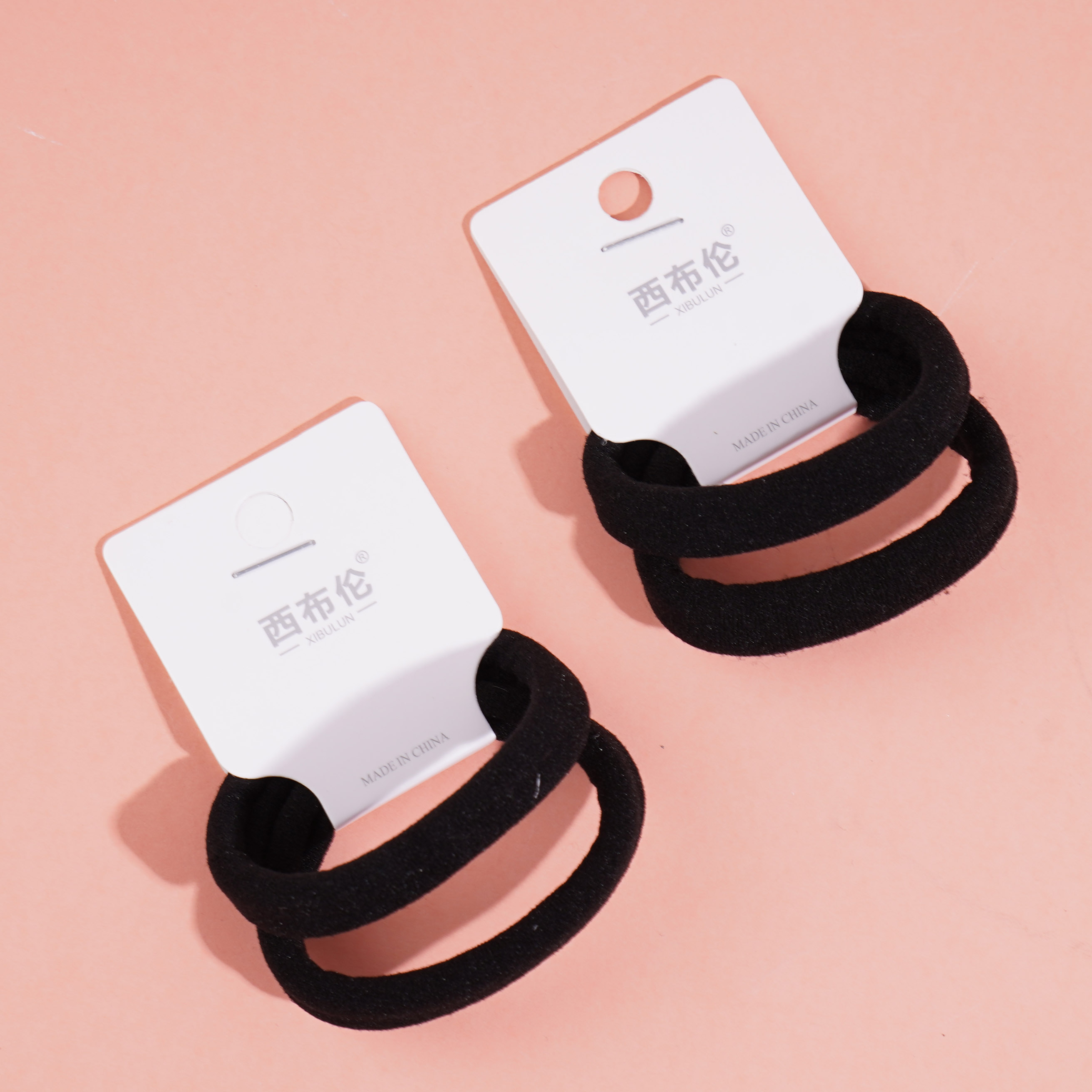 2 black towel loop-ended ropes and rubber bands