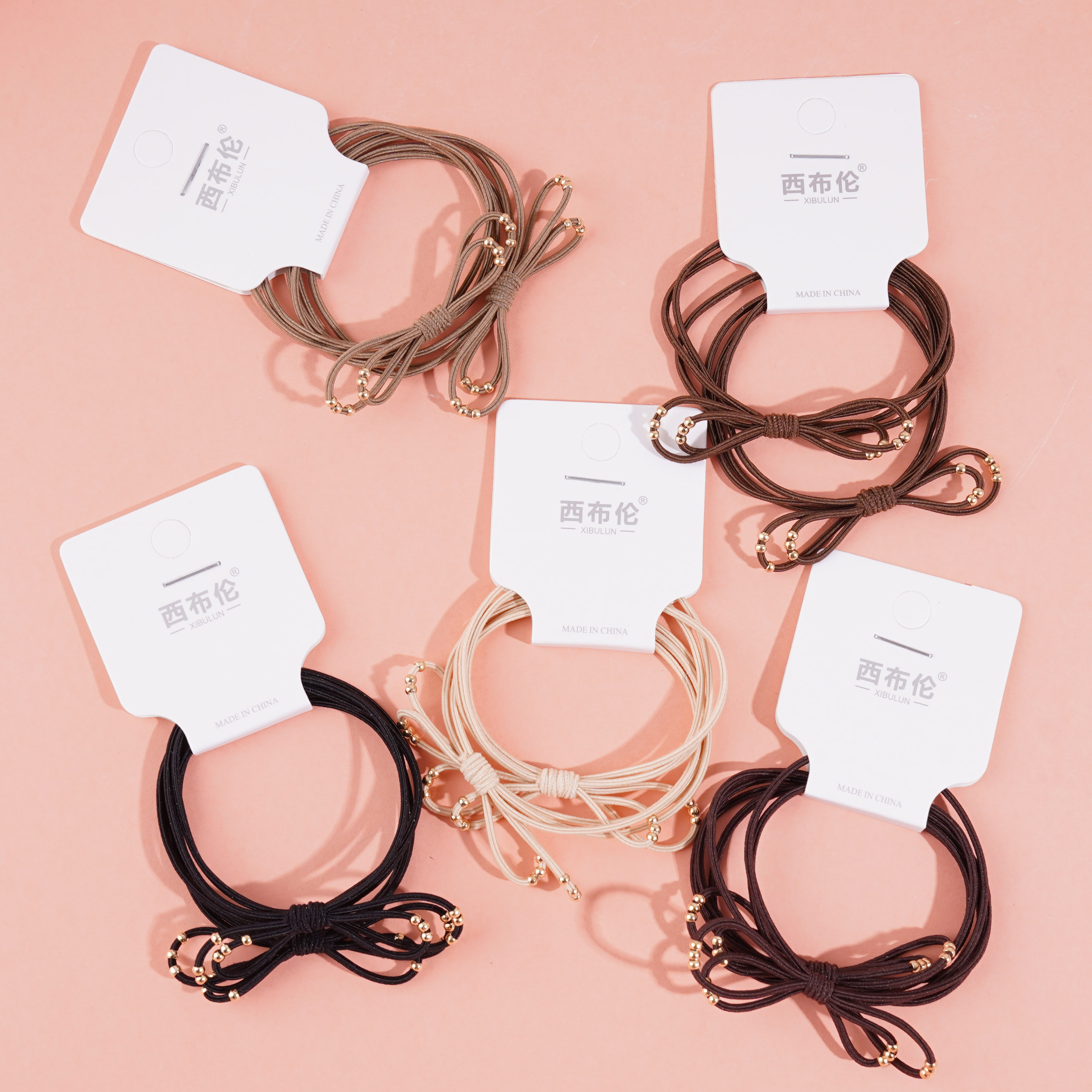 2 gold bead-decorated string elastics