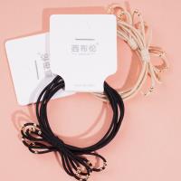 2 gold bead-decorated string elastics