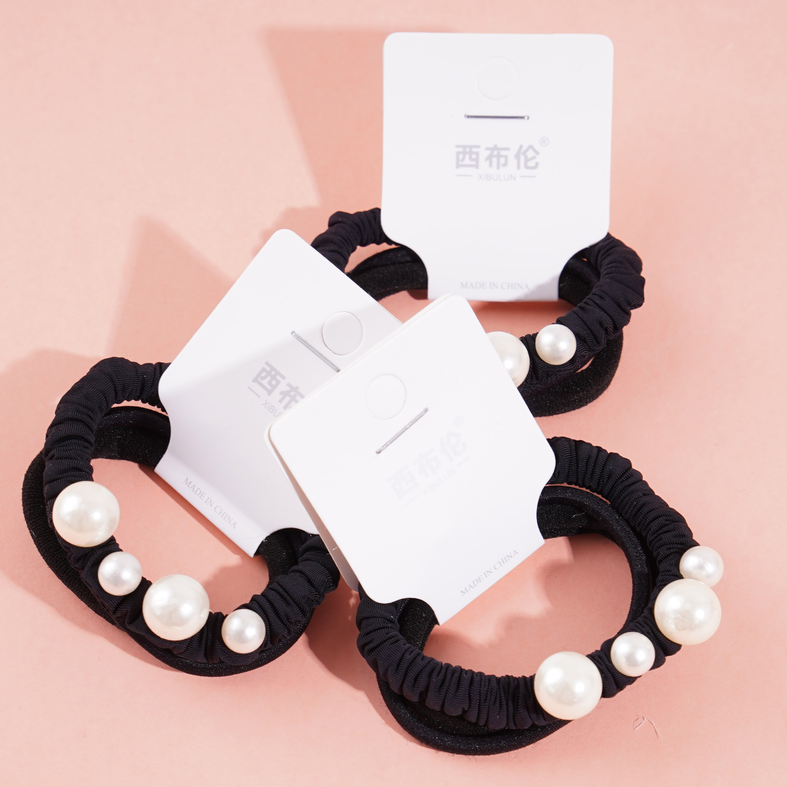 A headband made of three strands of hair with four pearls attached as decorations