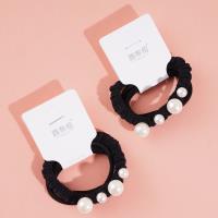 A headband made of three strands of hair with four pearls attached as decorations