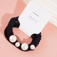 A headband made of three strands of hair with four pearls attached as decorations