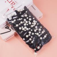 A headband made of three strands of hair with four pearls attached as decorations