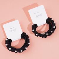 A set of three pearl sausage-shaped hair ties with a combined headband and elastic band design