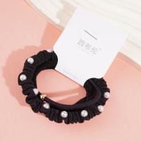 A set of three pearl sausage-shaped hair ties with a combined headband and elastic band design