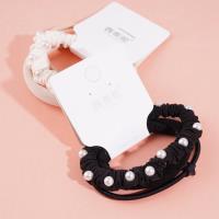 A set of three brown pearl hairbands with a headband and elastic bands