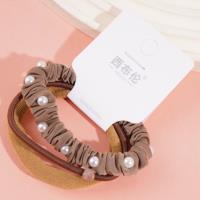 A set of three brown pearl hairbands with a headband and elastic bands