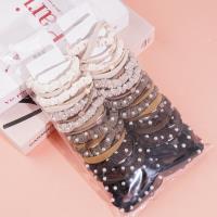 A set of three brown pearl hairbands with a headband and elastic bands